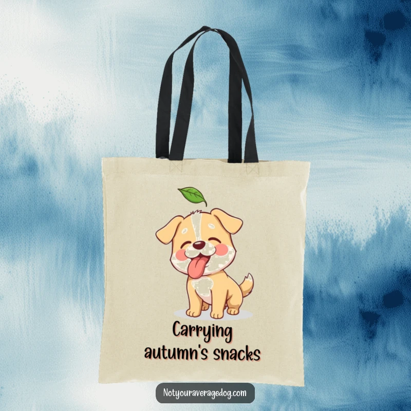 Funny tote bag showcasing a playful dog's comical effort to catch a floating autumn leaf.